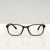 NUYU Afterlight blue light blocking glasses UK with black frames on white surface