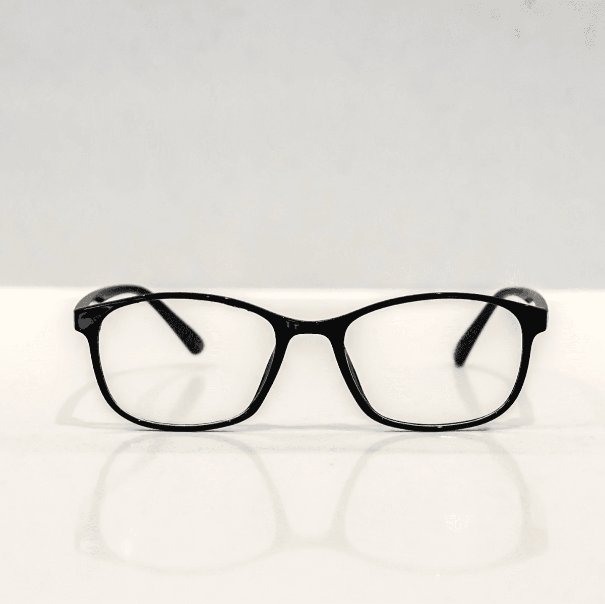 NUYU Afterlight blue light blocking glasses UK with black frames on white surface
