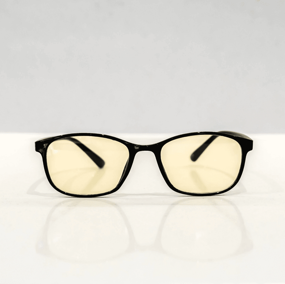 NUYU Afterlight blue light blocking glasses UK with yellow tinted lenses on white surface