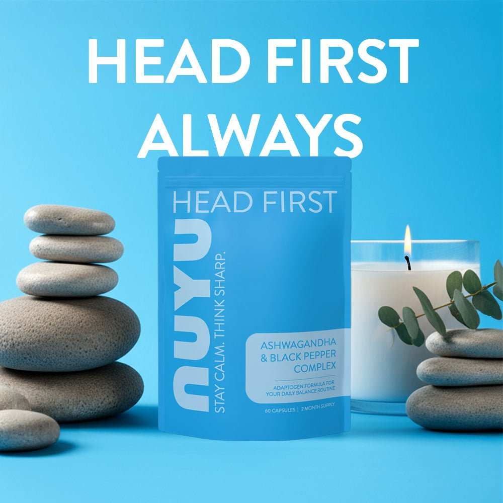 NUYU ashwagandha supplement UK blue packaging displayed with zen stones and eucalyptus