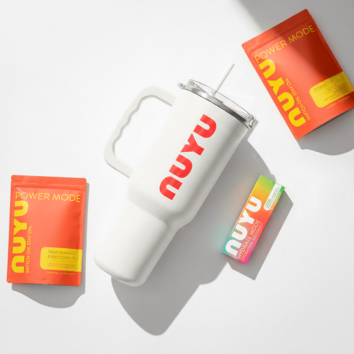 NUYU wellness supplement UK bundle with white tumbler and vibrant orange packaging