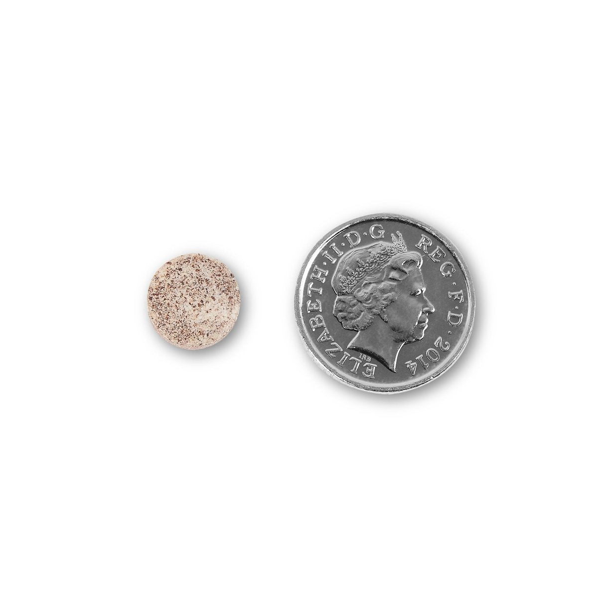 NUYU biotin supplement UK tablet size comparison next to British coin on white background
