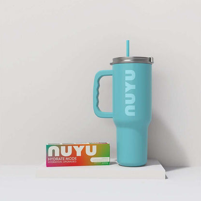 NUYU wellness supplement UK bundle with turquoise tumbler and colorful packaging on white surface