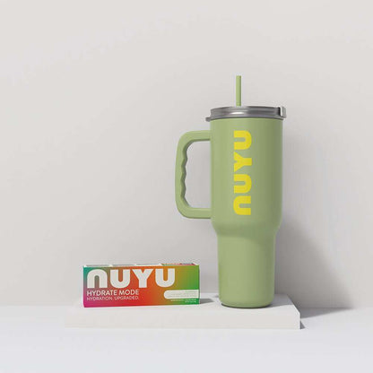 NUYU wellness supplement UK bundle with sage green tumbler and colorful packaging on white surface