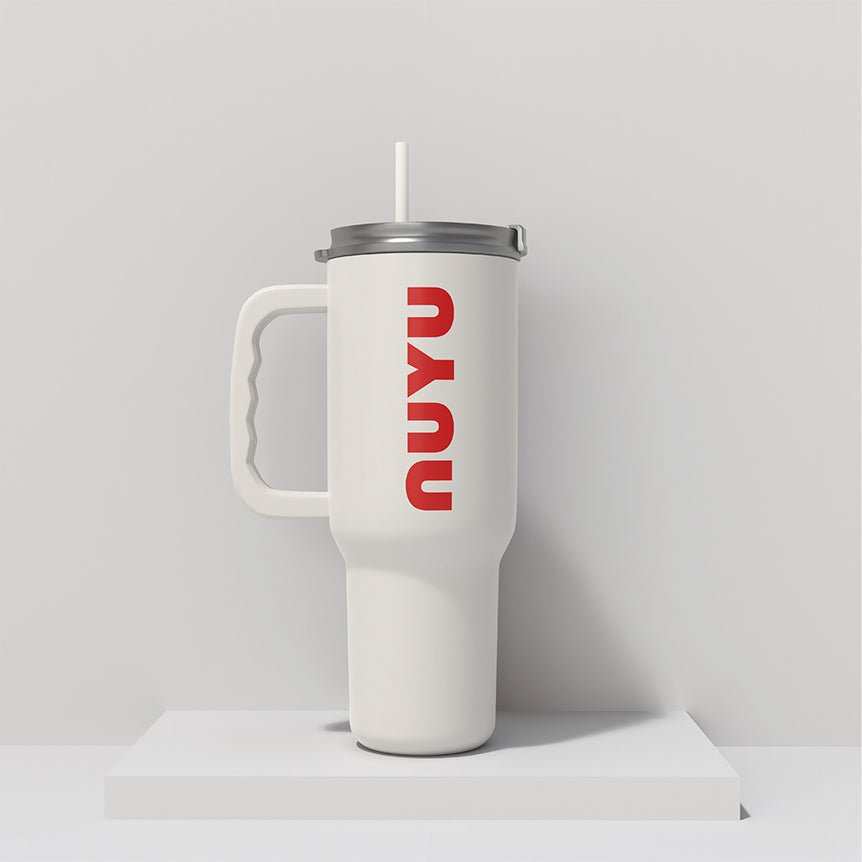 NUYU white insulated tumbler UK with red logo and straw on minimal background