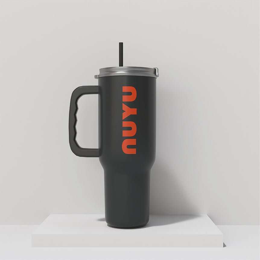 NUYU dark green insulated tumbler with orange logo and black straw on white surface