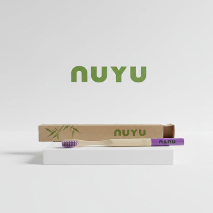 NUYU Happy Toothbrush with purple bristles and eco packaging from UK wellness supplement brand