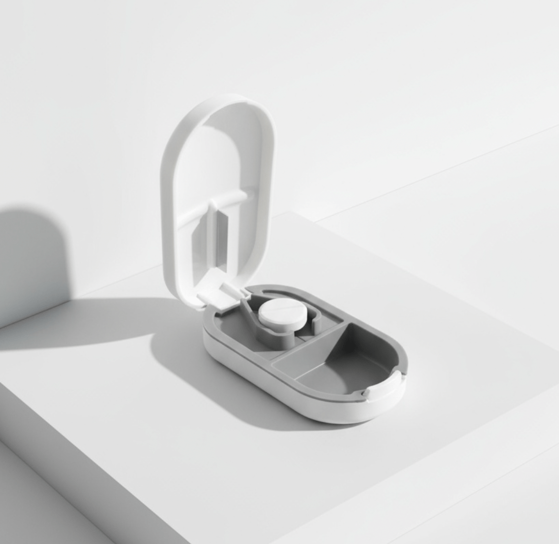 NUYU Slice pill cutter open case showing precision blade, wellness supplement UK cutting tool