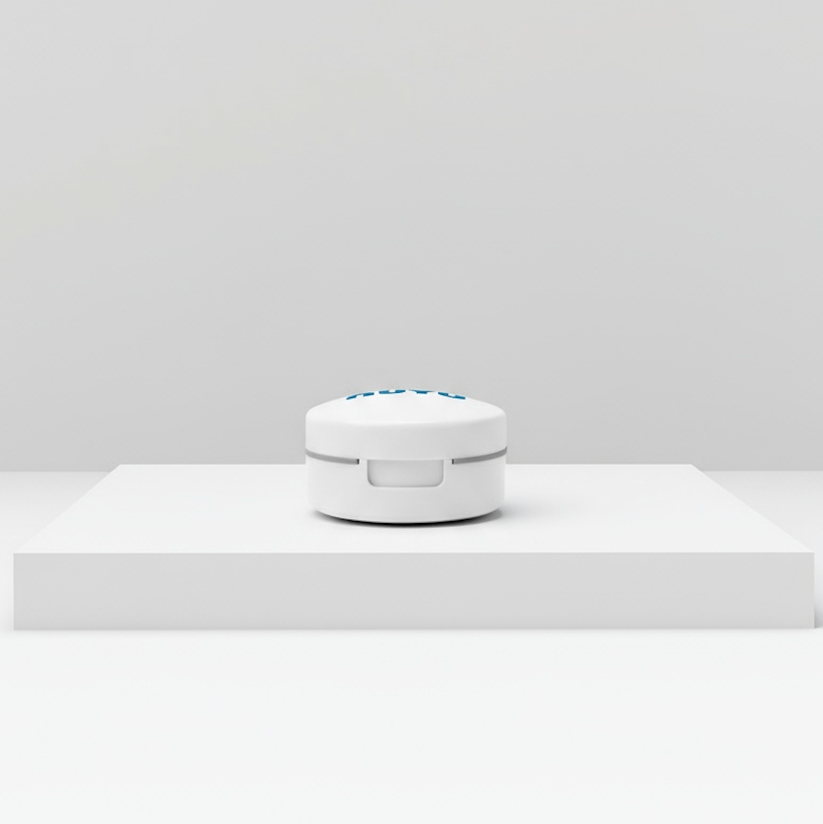 NUYU white pill cutter device on minimalist surface, wellness supplement UK accessory